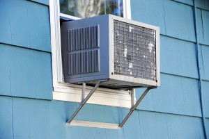 old air conditioner installed on window of house
